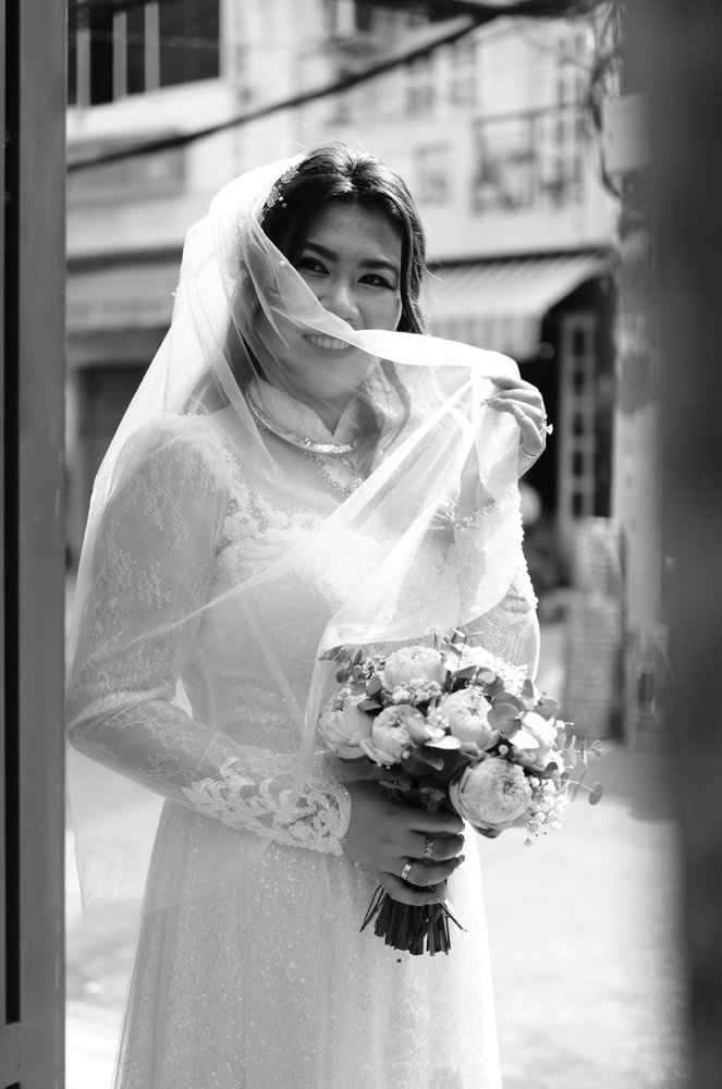 Isla beneath her veil by a window, black and white film portrait — Ashcombe Manor